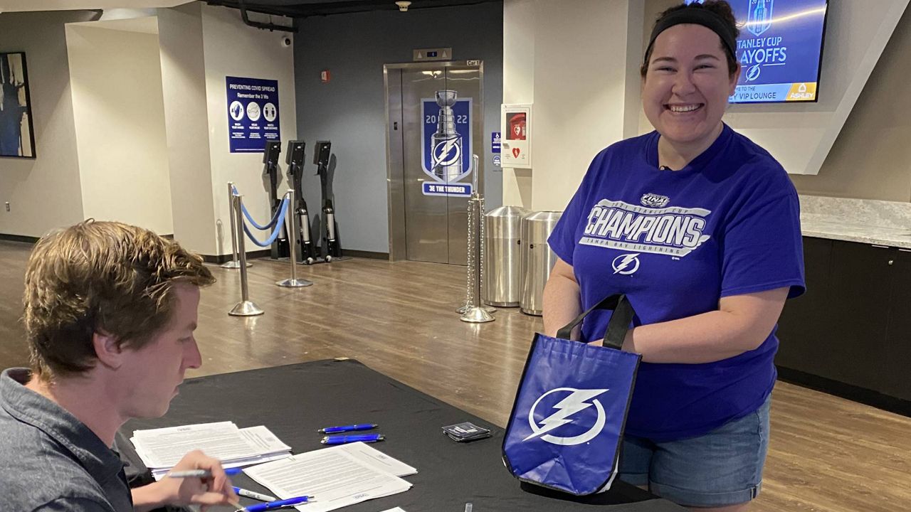 Tampa Bay Lightning fan Olivia Beck brought her Lightning bolt necklace charms and earrings as a lucky charm to support the team. (Josh Rojas/Bay News 9)