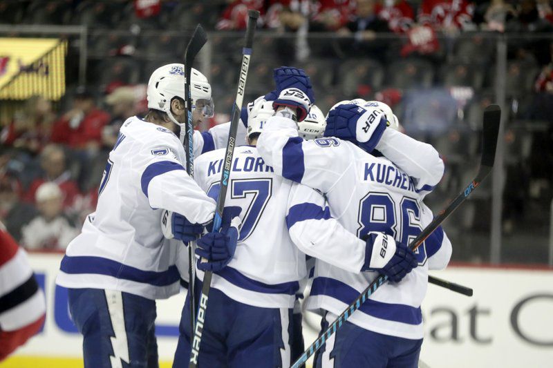 Tampa Bay Lightning players celebrate a goal by left wing Alex Killorn (17) during the second period of Game 3 of an NHL first-round hockey playoff series against the New Jersey Devils, Monday, April 16, 2018, in Newark, N.J. (AP Photo/Julio Cortez)