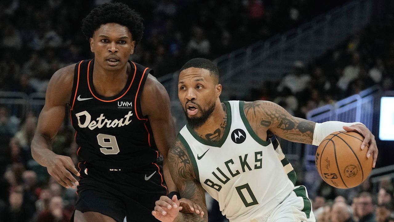 Milwaukee Bucks' Damian Lillard gets past Detroit Pistons' Ausar Thompson during the first half of an NBA basketball game Wednesday, Nov. 8, 2023, in Milwaukee. 