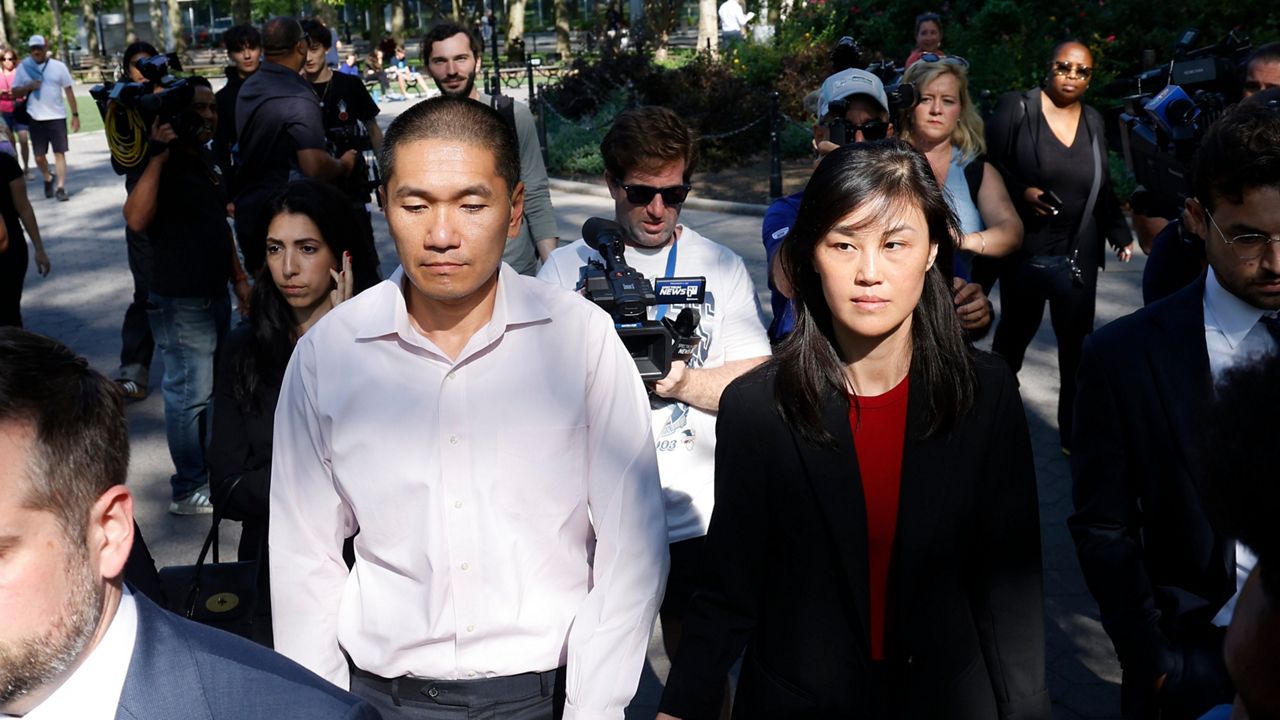 christopher hu and linda sun walk away from court building while followed by press members