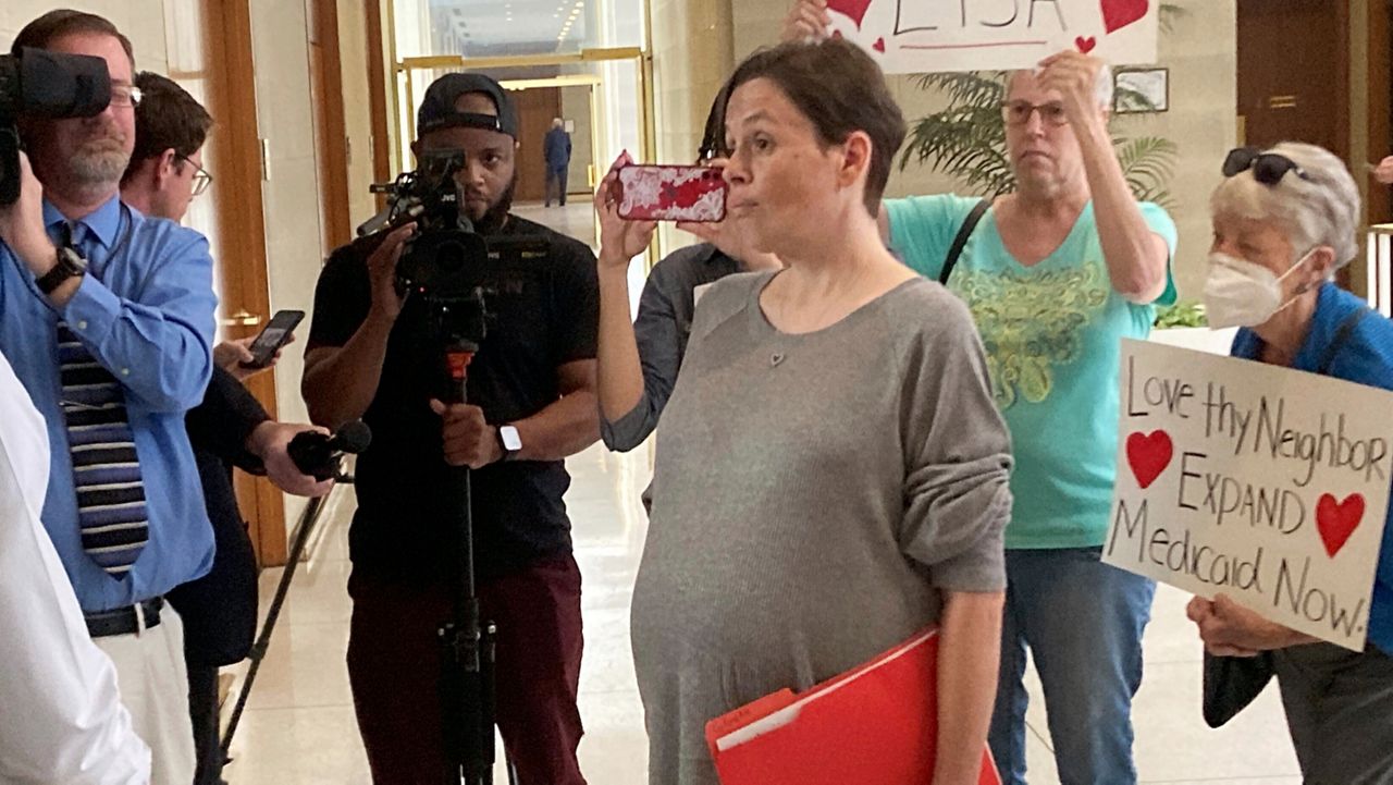 Lisa Franklin, right, of Forest City, N.C., speaks to a staff member of Senate leader Phil Berger's office about the need for Medicaid expansion, Wednesday, Sept. 30, 2023, at the Legislative Building in Raleigh, N.C. (AP Photo/Gary D. Robertson)