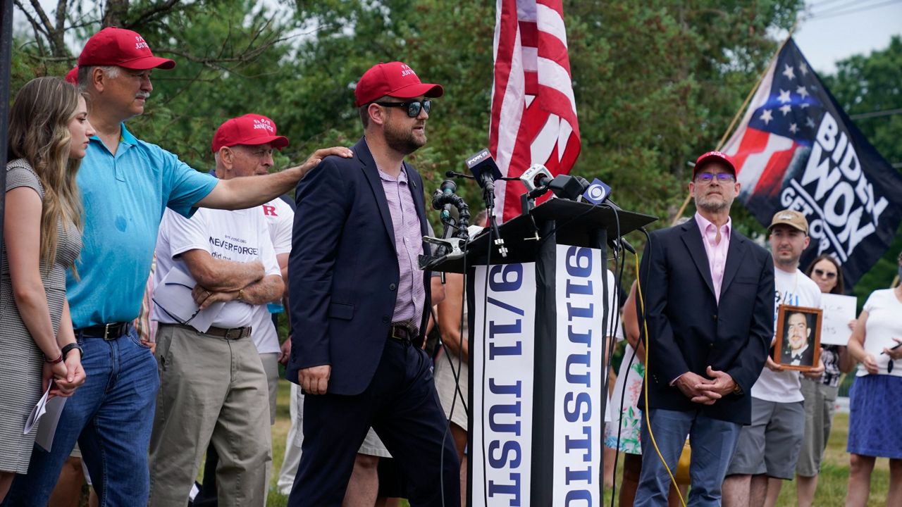 Families and survivors of the 9/11 terror attacks attend a news conference Friday near the site of the Bedminster Invitational LIV Golf tournament in Bedminster, N.J. (AP Photo/Seth Wenig)