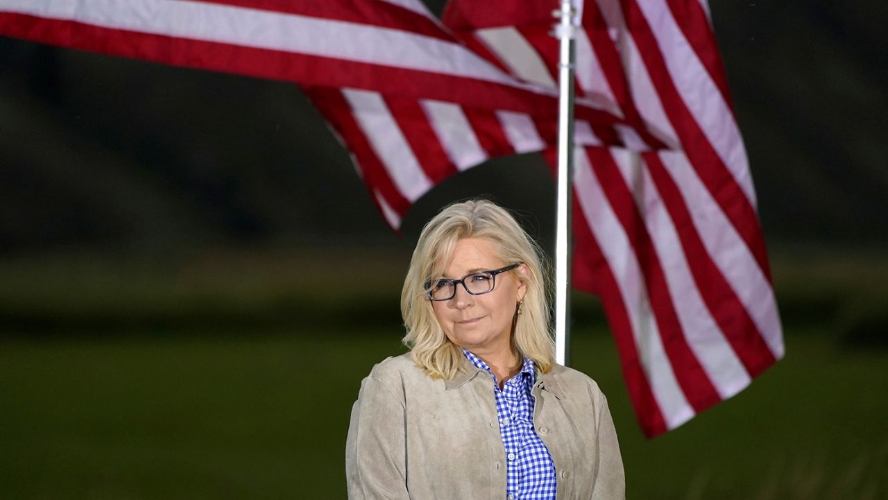Rep. Liz Cheney, R-Wyo., waits by flags before speaking, Tuesday, Aug. 16, 2022, at an Election Day gathering in Jackson, Wyo. (AP Photo/Jae C. Hong)