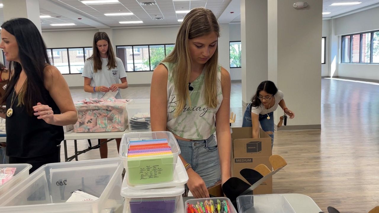Abbie Hohl putting together a locker box (Spectrum News 1/Alex Wilkinson)
