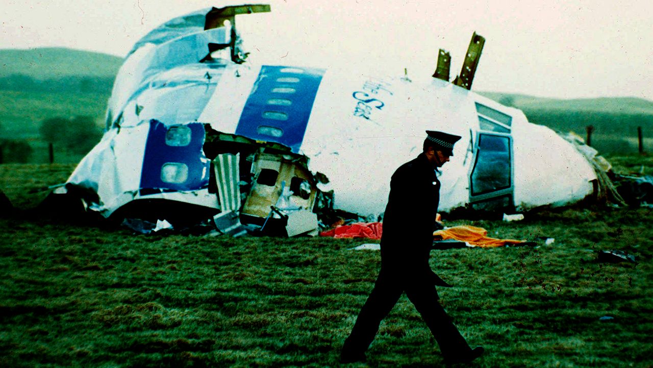 A police officer walks by the nose of Pan Am flight 103 in a field near the town of Lockerbie, Scotland where it lay after a bomb aboard exploded, killing a total of 270 people, on Wednesday, Dec. 21, 1988.