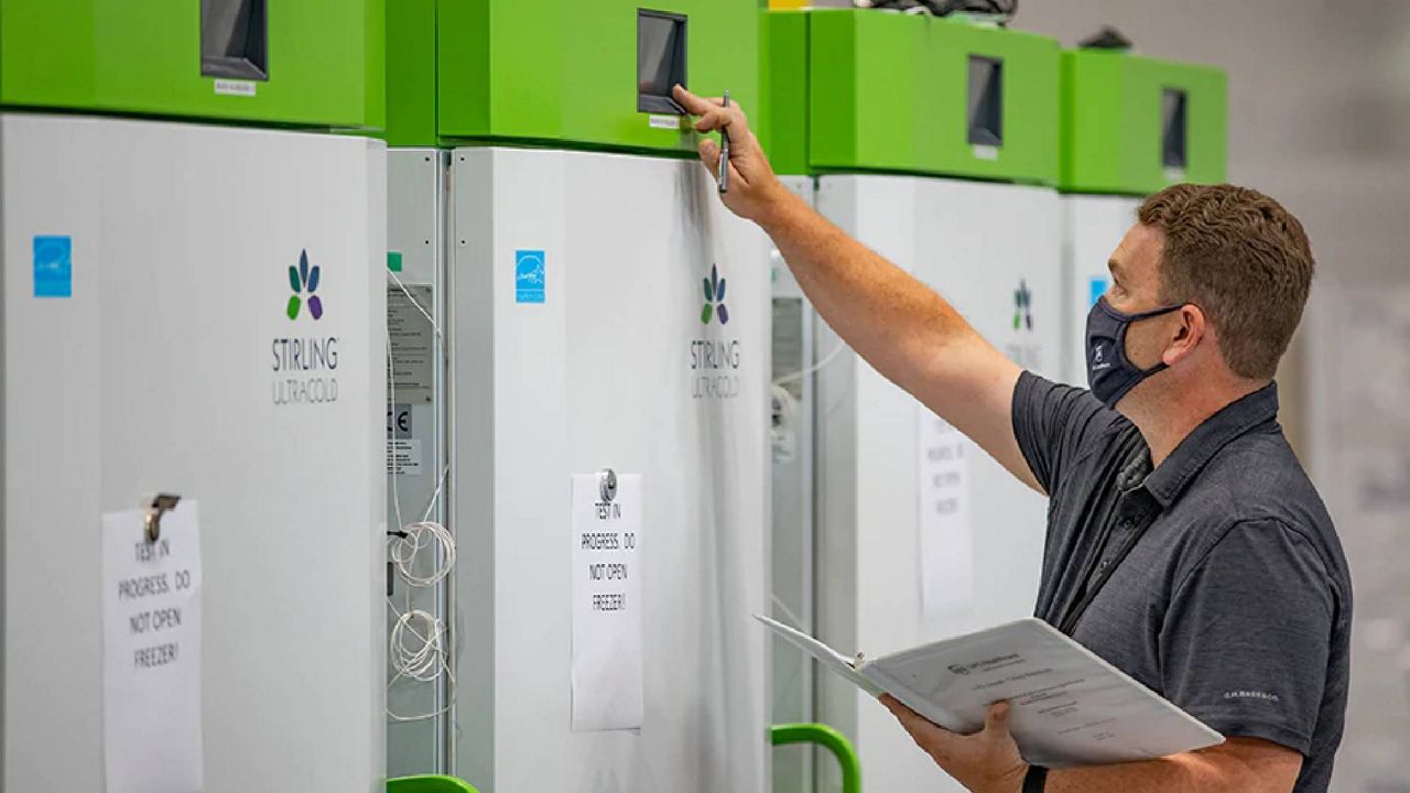 An employee checks freezers to be used to store vaccines at UPS facilities. The company is also manufacturing and shipping dry ice along with vaccine doses. (Courtesy of UPS)