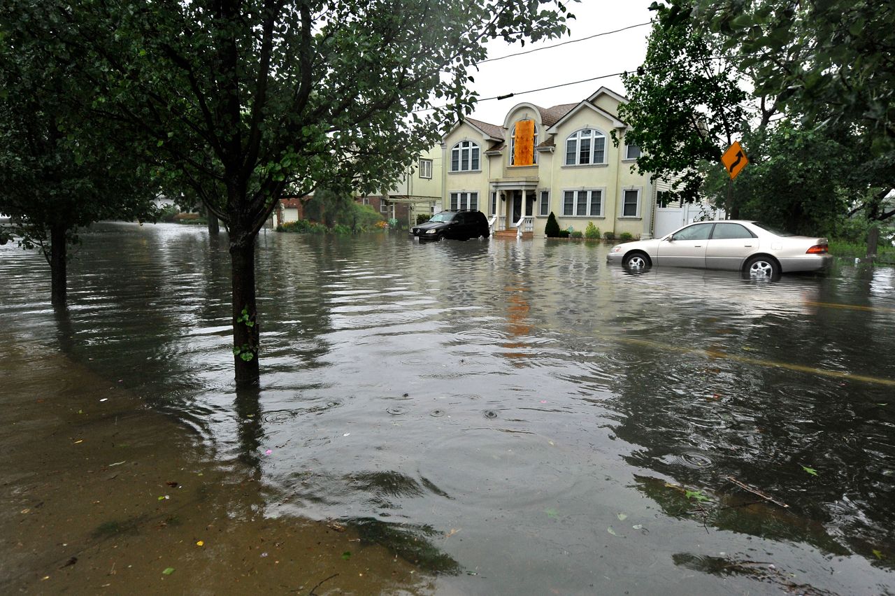 Pearl Street in the Long Island town of East Rockaway, N.Y., is flooded after Tropical Storm Irene swept through the area Sunday, Aug. 28, 2011. (AP Photo/Kathy Kmonicek)