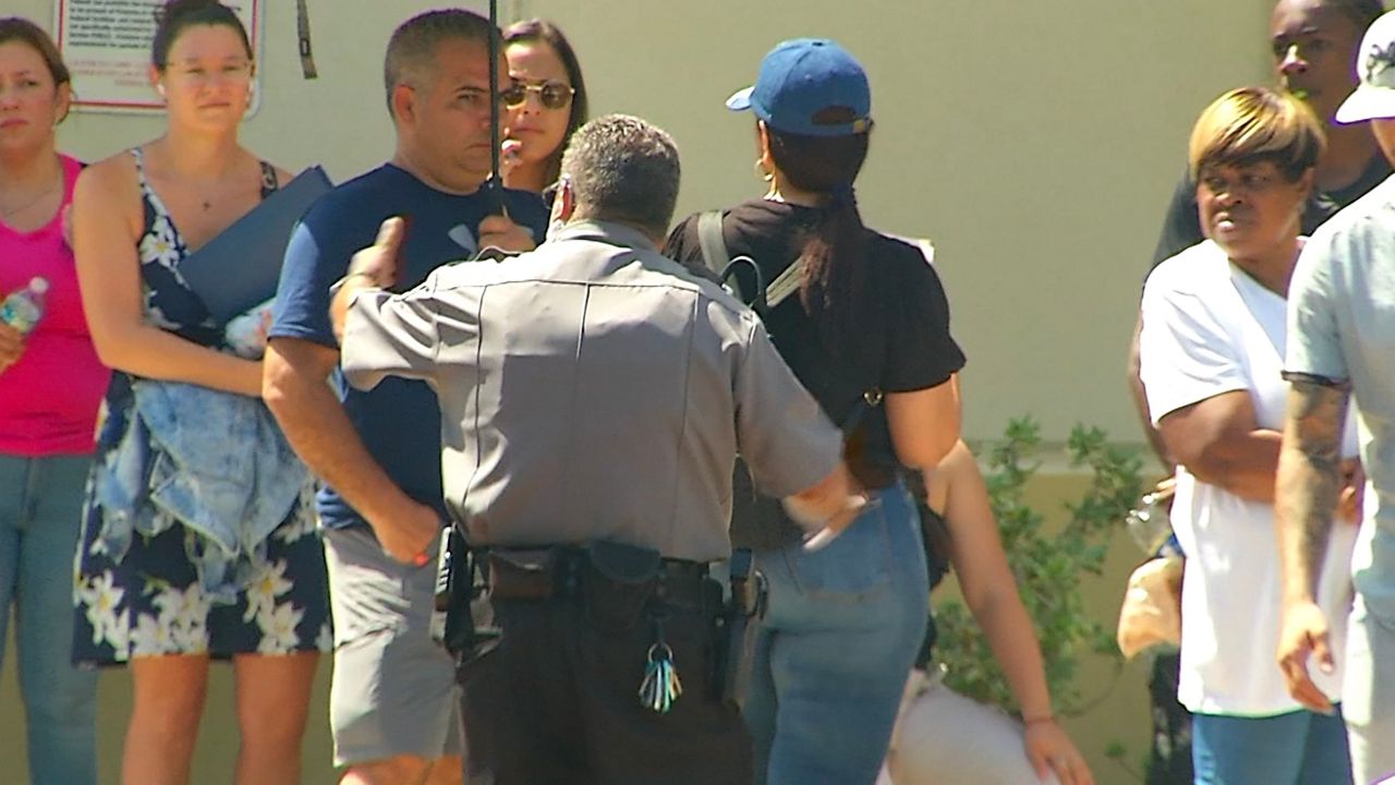 For the second day in a row, more than a hundred people waited in line in the hot sun to receive assistance at the U.S. Social Security office in Orlando. (Spectrum News 13/Jesse Canales)