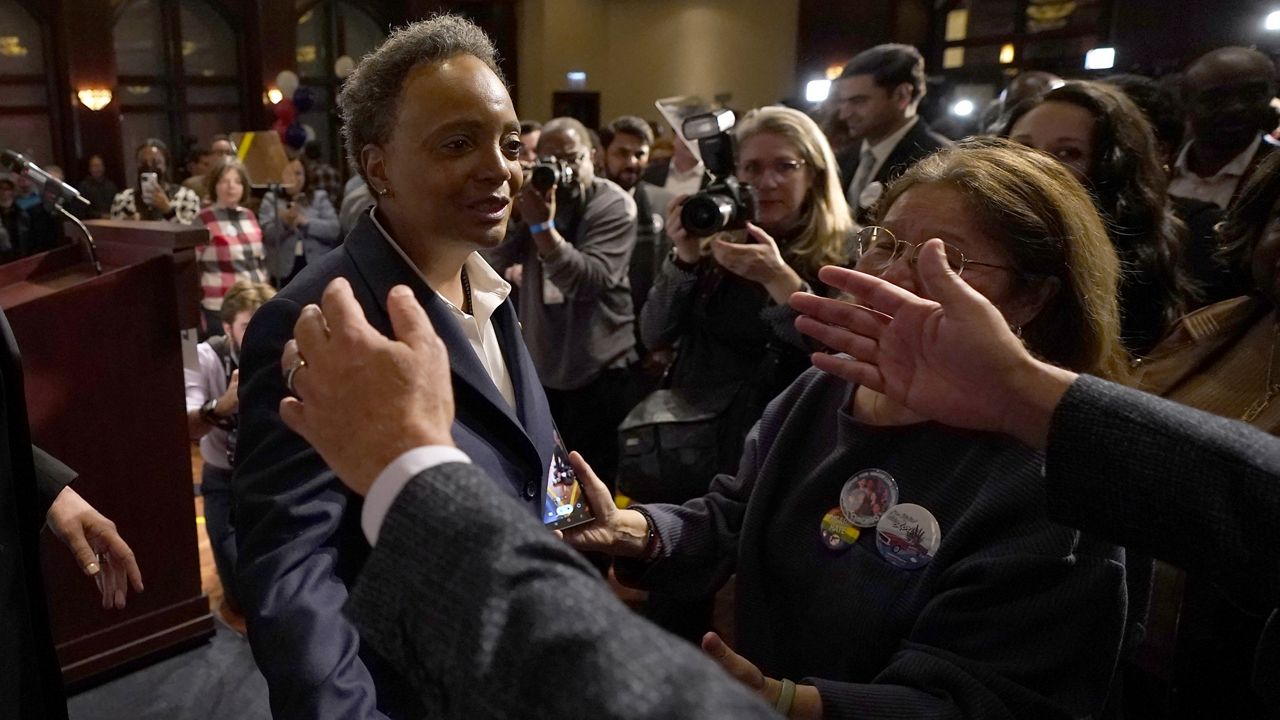 Chicago Mayor Lori Lightfoot, left, walks into the open arms of a supporter after conceding the mayoral election late Tuesday in Chicago. (AP Photo/Charles Rex Arbogast)