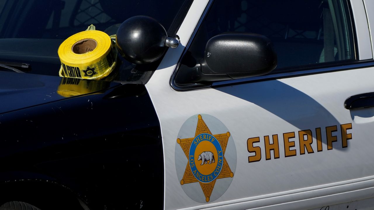 A roll of police tape is left on the windshield of Los Angeles County sheriff's vehicle in the parking lot of its training academy in Whittier, Calif., Wednesday, Nov. 16, 2022. A car struck 22 LA County sheriff's recruits on a training run around dawn Wednesday and five were critically injured, authorities said. (AP Photo/Jae C. Hong)