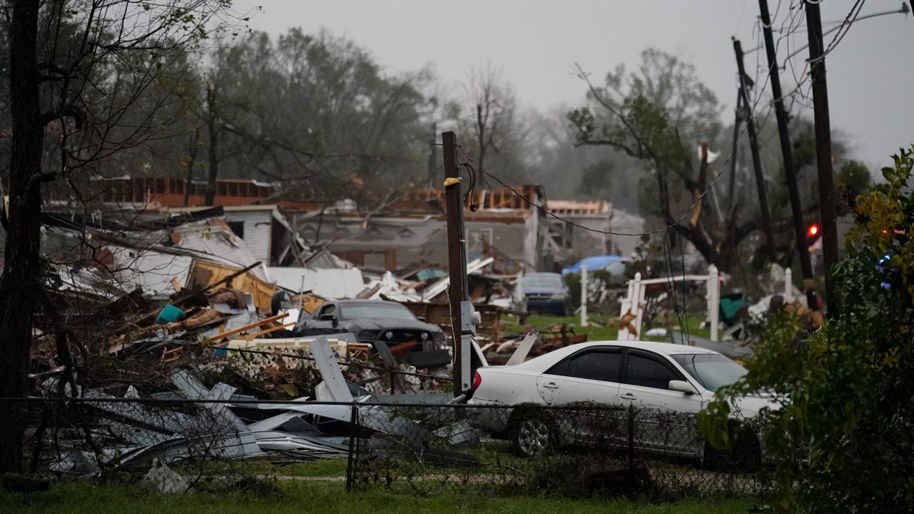 Vehicles and debris are strewn about Wednesday after a tornado that tore through the area in Killona, La., about 30 miles west of New Orleans. (AP Photo/Gerald Herbert)