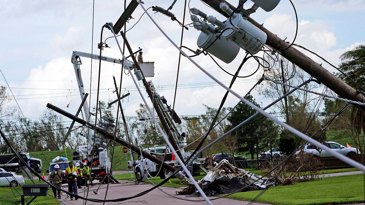 Crews begin work on downed power lines leading to a fire station in Waggaman, La., as residents try to recover from the effects of Hurricane Ida. (AP/Steve Helber)