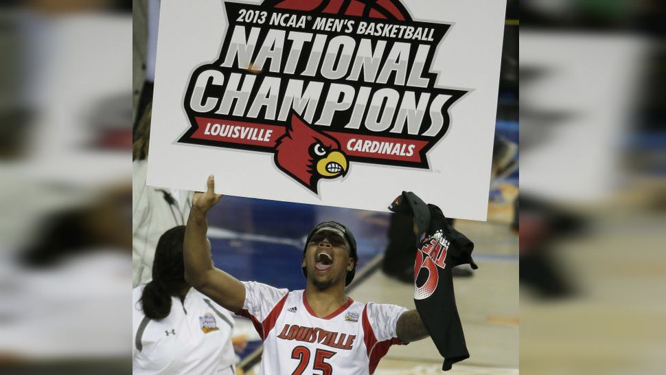 In this April 8, 2013, file photo, Louisville center Zach Price holds sinage after Louisville defeated Michigan 82-76 in the NCAA Final Four tournament college basketball championship game, in Atlanta. (AP Photo/Chris O'Meara, File) 
