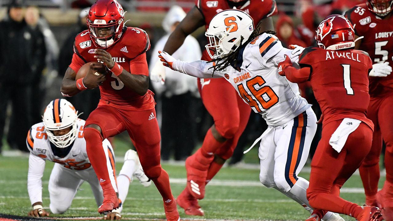Louisville quarterback Malik Cunningham (3) runs from the attempted tackle of Syracuse linebacker Lakiem Williams (46) during the first half of an NCAA college football game in Louisville, Ky., Saturday, Nov. 23, 2019. (AP Photo/Timothy D. Easley)