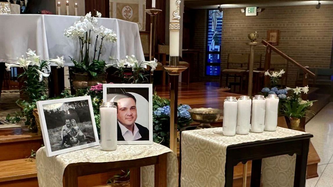 A memorial for Joshua Barrick is on display, late Monday, April 10, 2023, at Holy Trinity Catholic Church in Louisville, Ky. A Louisville bank employee armed with a rifle opened fire at the bank Monday morning, killing Barrick and multiple others, including a close friend of Kentucky's governor, while livestreaming the attack on Instagram, authorities said. (AP Photo/Claire Galofaro)