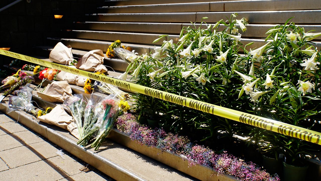 A memorial of flowers at the Old National Bank in downtown Louisville, Kentucky. Five people were killed on April 10, 2023 by an employee of the bank. (Spectrum News 1/Mason Brighton)