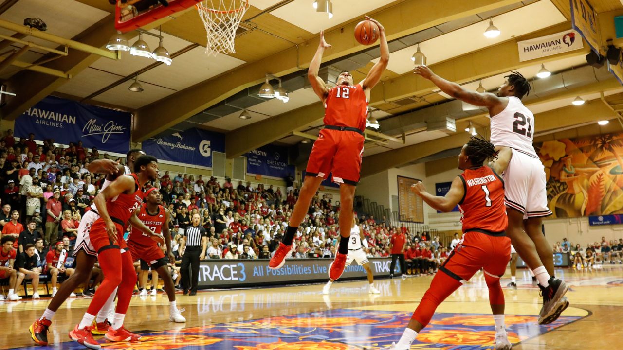 Texas Tech forward Daniel Batcho (12) grabs a rebound against Louisville during the first half of an NCAA college basketball game, Tuesday, Nov. 22, 2022, in Lahaina, Hawaii. (AP Photo/Marco Garcia)