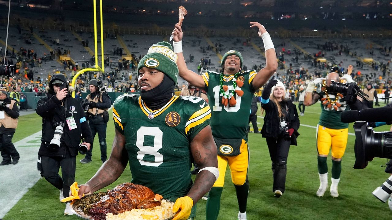 Green Bay Packers running back Josh Jacobs (8) and quarterback Jordan Love (10) walk off the field after an NFL football game