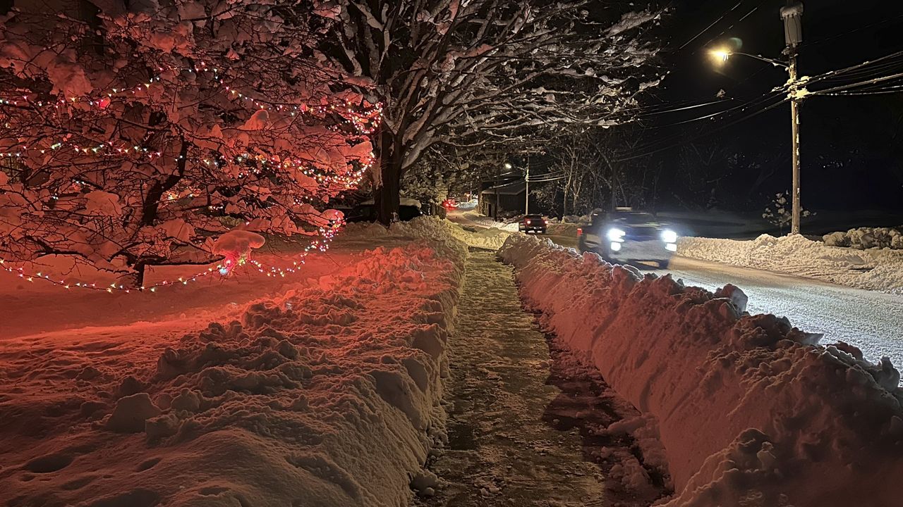 Drivers take advantage of the lull between lake-effect snowfalls in Lowville, N.Y., on Saturday, Nov. 30, 2024. (AP Photo/Cara Anna)