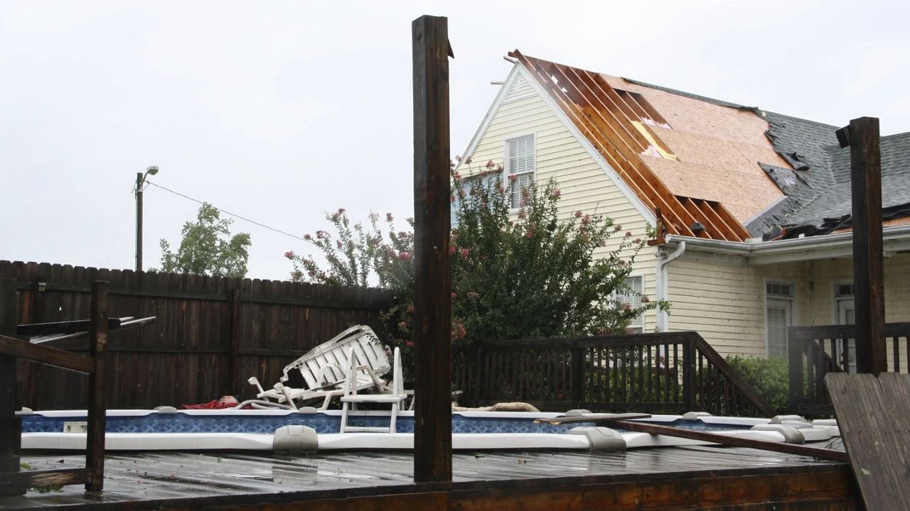 Part of the roof of Genesis Cooper's home is shown blown off after a tornado, spawned by Tropical Storm Debby, passed through Lucama, N.C., on Thursday, Aug. 8, 2024. (AP Photo/Makiya Seminera)