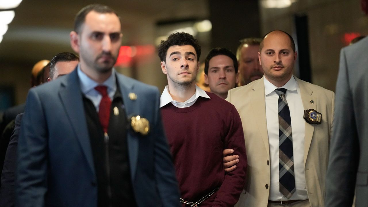 Luigie Mangione is escorted into Manhattan Criminal court for his arraignment on state murder and terror charges in the killing of UnitedHealthcare CEO Brian Thompson, Monday, Dec. 23, 2024, in New York. (AP Photo/Seth Wenig)