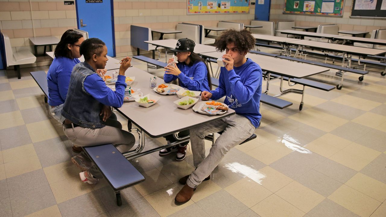 Students eat lunch at Edward A. Reynolds West Side High School in New York on Tuesday, Dec. 10, 2019.