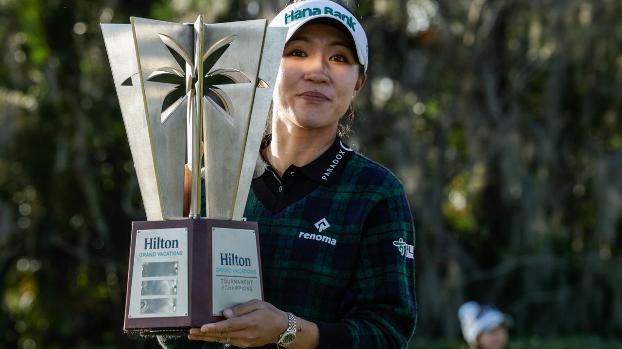 Lydia Ko shows off the trophy after winning the Hilton Grand Vacations Tournament of Champions LPGA golf tournament on Jan. 21, 2024. (AP Photo/Kevin Kolczynski)