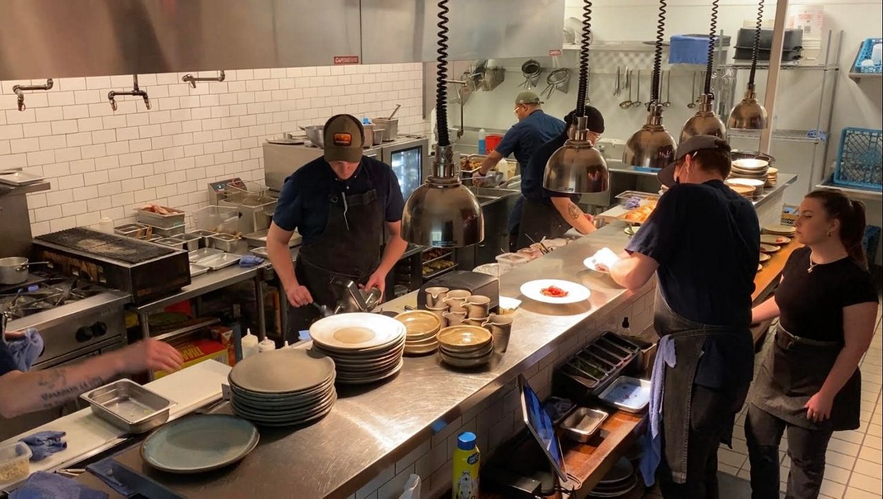 Machete staff prepares dinner for customers