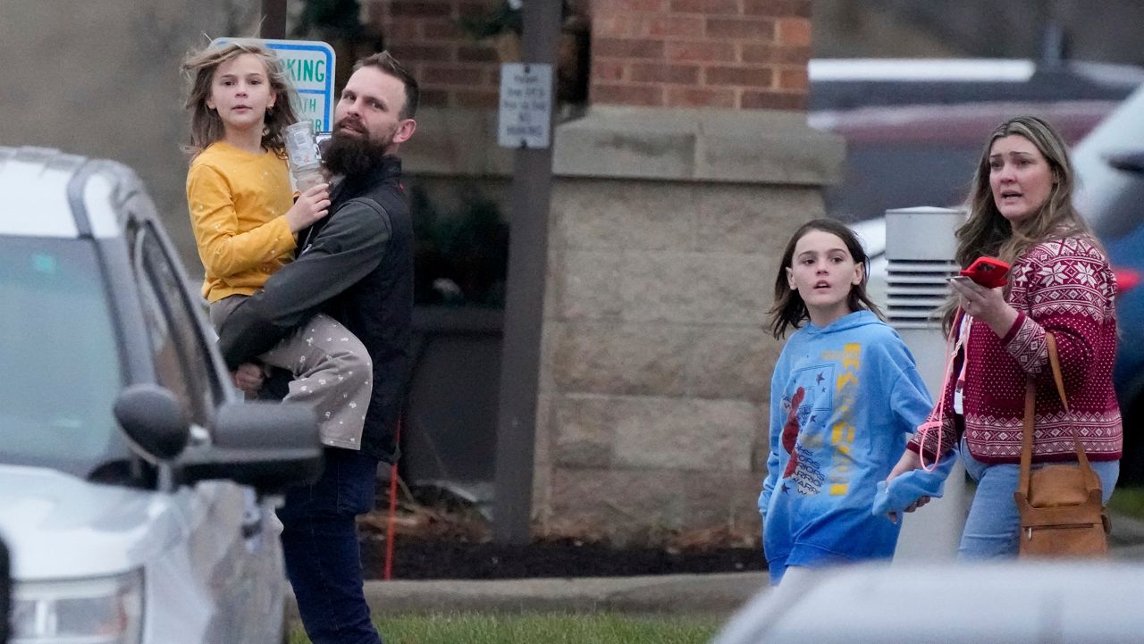 Families leave the reunification center, following a shooting, Monday, Dec. 16, 2024 in Madison, Wis. (AP Photo/Morry Gash)