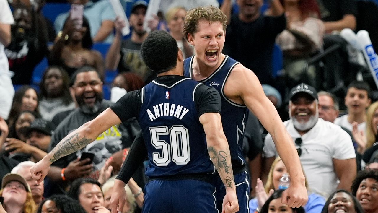 Orlando Magic center Moritz Wagner, right, celebrates as he gets a chest bump from guard Cole Anthony (50) after dunking the ball against the Chicago Bulls and drawing a foul during the second half of an NBA basketball game, Sunday, April 7, 2024, in Orlando, Fla. (AP Photo/John Raoux)