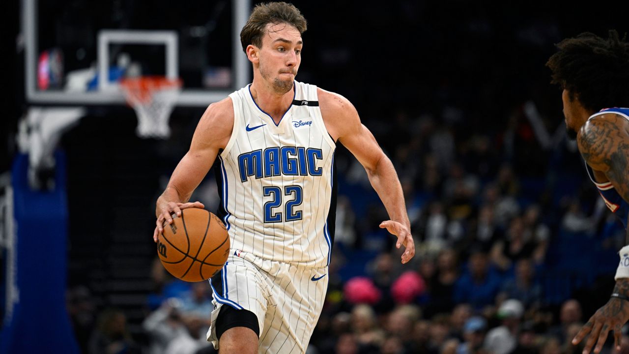 Orlando Magic forward Franz Wagner (22) drives to the basket against the Philadelphia 76ers during the first half of a preseason NBA basketball game, Friday, Oct. 18, 2024, in Orlando, Fla. (AP Photo/Phelan M. Ebenhack)