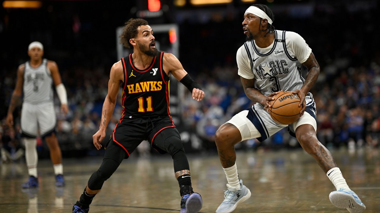 Orlando Magic guard Kentavious Caldwell-Pope (3) is defended by Atlanta Hawks guard Trae Young (11) during the second half of an NBA basketball game, Monday, Feb. 10, 2025, in Orlando, Fla. (AP Photo/Phelan M. Ebenhack)