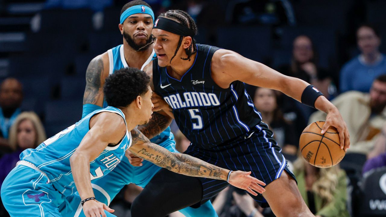 Paolo Banchero (right) and the rest of the Magic will begin their NBA Cup competition against Tre Mann (far left), Miles Bridges and the rest of the Hornets on Nov. 12 at Kia Center. (AP Photo/Nell Redmond)