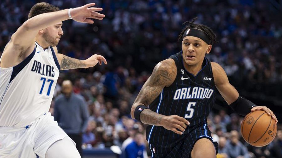 Orlando Magic forward Paolo Banchero (5) battles Dallas Mavericks guard Luka Doncic (77) for space during the second half of an NBA basketball game, Sunday, Oct. 30, 2022, in Dallas. (AP Photo/Brandon Wade)