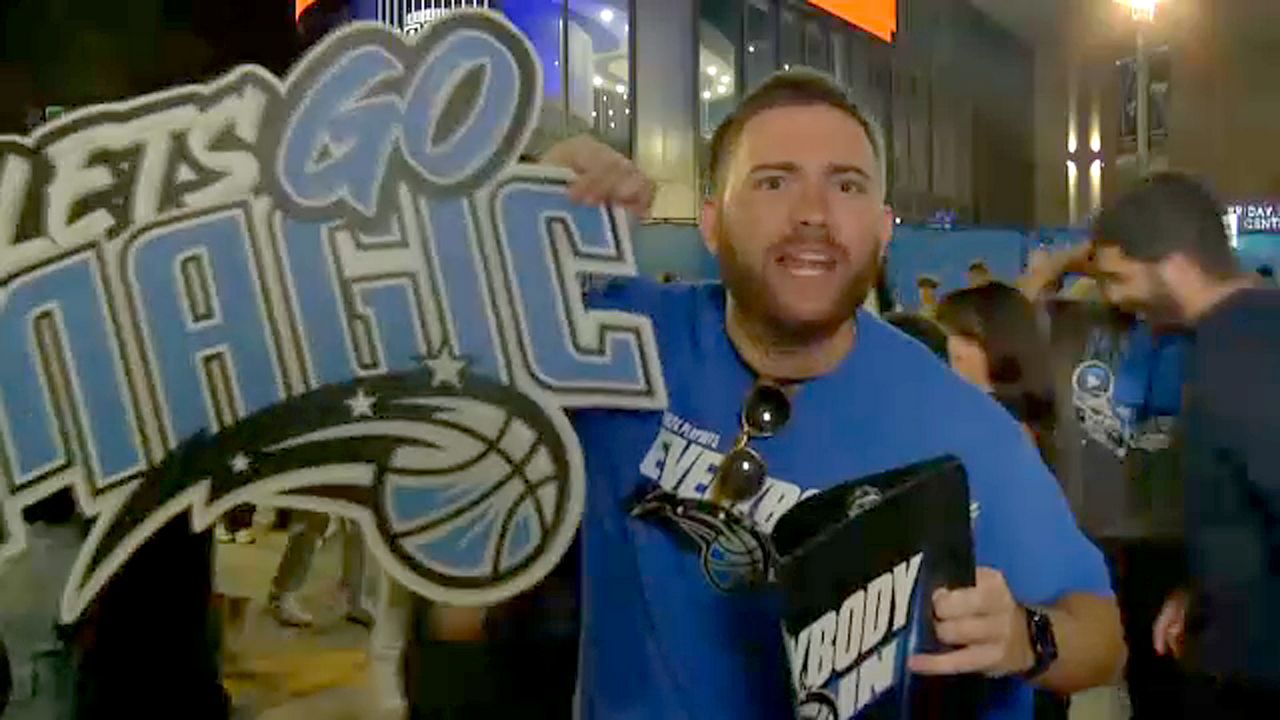 An Orlando Magic fan celebrates Friday night after the team beat the Cleveland Cavaliers 103-96 to force Game 7 in the series. (Spectrum News)