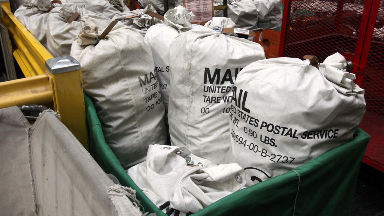 In this photo taken Feb. 24, 2012, sacks of mail for processing is seen at the Sacramento Processing Center in West Sacramento, Calif. Elections officials in several states are concerned that the closing of mail-processing centers and post offices could disrupt vote-by-mail balloting this year.(AP Photo/Rich Pedroncelli)