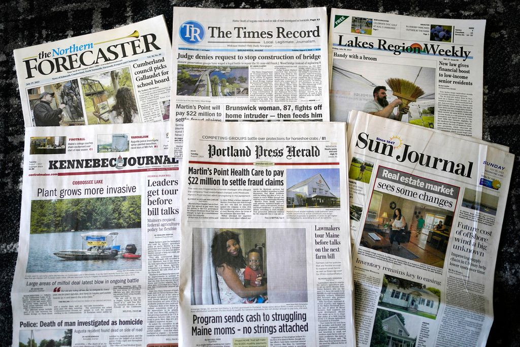 A sample of the Maine daily and weekly newspapers is seen, Tuesday, Aug. 1, 2023, in Augusta, Maine. The publications are part of a group of 20 newspapers formerly owned by Masthead Maine, the largest newspaper group in the state. The media network was sold to the nonprofit Maine Trust for Local News. (AP Photo/Robert F. Bukaty)