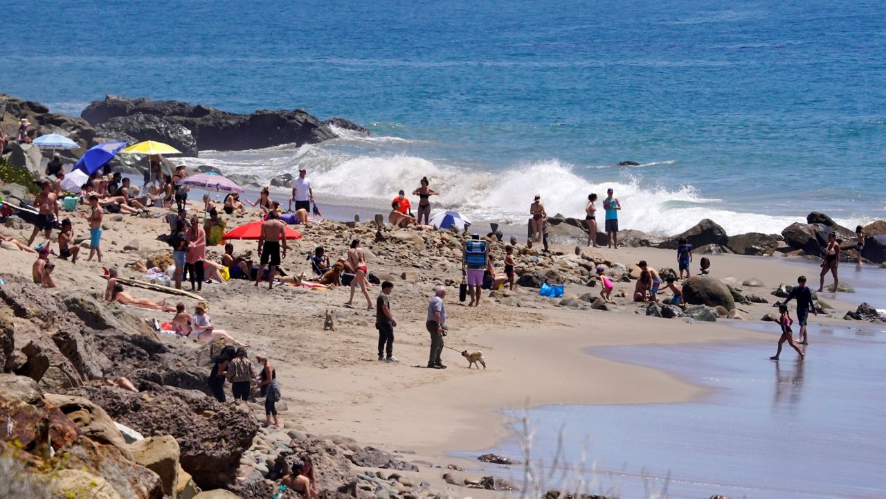 Several people utilize a beach, Friday, April 24, 2020, in Malibu, Calif. (AP Photo/Mark J. Terrill)