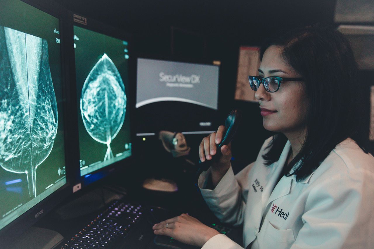 Rifat Wahab, DO, UC Health breast radiologist, reviews a traditional breast mammography image. (Photo courtesy of UC Health)