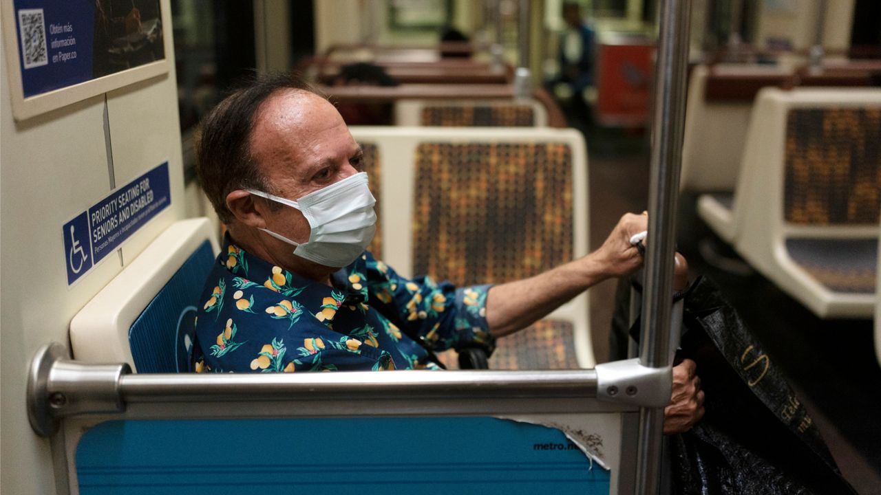 Yousey Kamel, 62, wears a face mask while riding in a Los Angeles Metro train in Los Angeles, Wednesday, July 13, 2022. (AP Photo/Jae C. Hong)