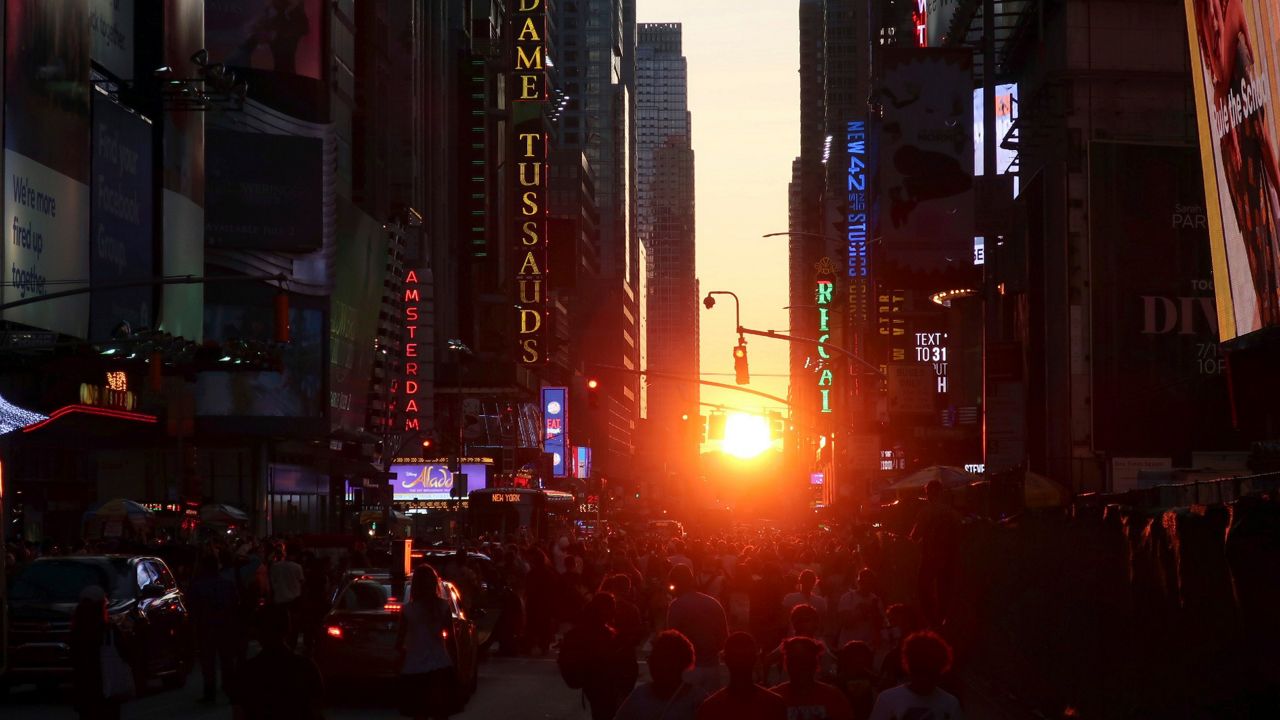 People view a Manhattanhenge sunset on Friday, July 12, 2019, in New York. (AP Photo/Ted Shaffrey/File)