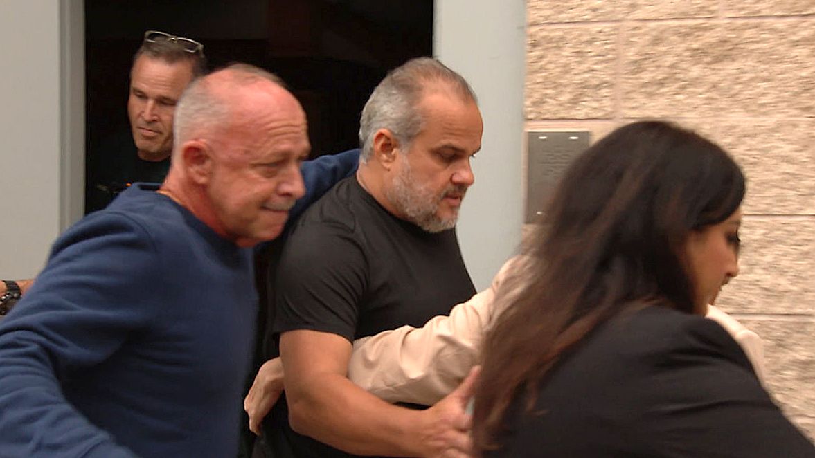 Suspended Osceola County Sheriff Marcos Lopez (center) leaves the Lake County Jail after bonding out Thursday night. (Spectrum News/Christopher Krul)