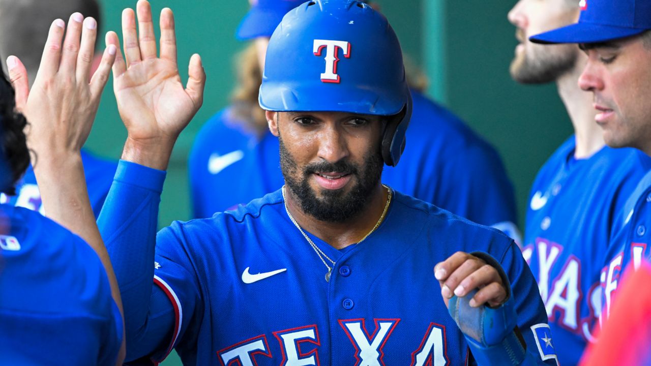 Texas Rangers' Marcus Semien is congratulated after scoring against the Kansas City Royals during the first inning of a baseball game Tuesday, June 28, 2022, in Kansas City, Mo. (AP Photo/Reed Hoffmann)