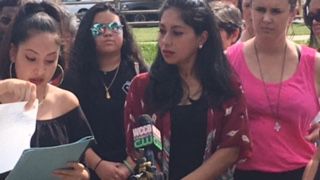 arrested mom standing at microphone