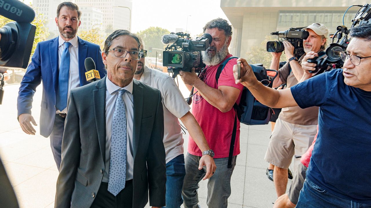 Dr. Mark Chavez, a physician from San Diego, second from left, who is charged in connection with actor Matthew Perry's death from an accidental ketamine overdose, with his criminal defense attorney Matthew Binninger, far left, arrive for a change of plea hearing at the United States Courthouse in Los Angeles on Wednesday. (AP Photo/Damian Dovarganes)