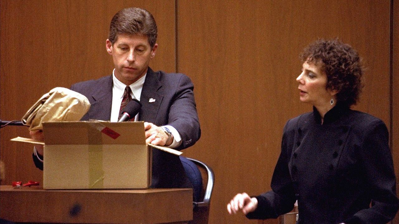 Los Angeles Police Detective Mark Fuhrman shows the jury in the O.J. Simpson double murder trial evidence during testimony on March 10, 1995, in Los Angeles. Fuhrman, 72, who was convicted of lying on the witness stand in the O.J. Simpson trial three decades ago, is now barred from law enforcement under a California police reform law meant to strip the badges of police officers who act criminally or with bias. (AP Photo/Nick Ut, Pool)