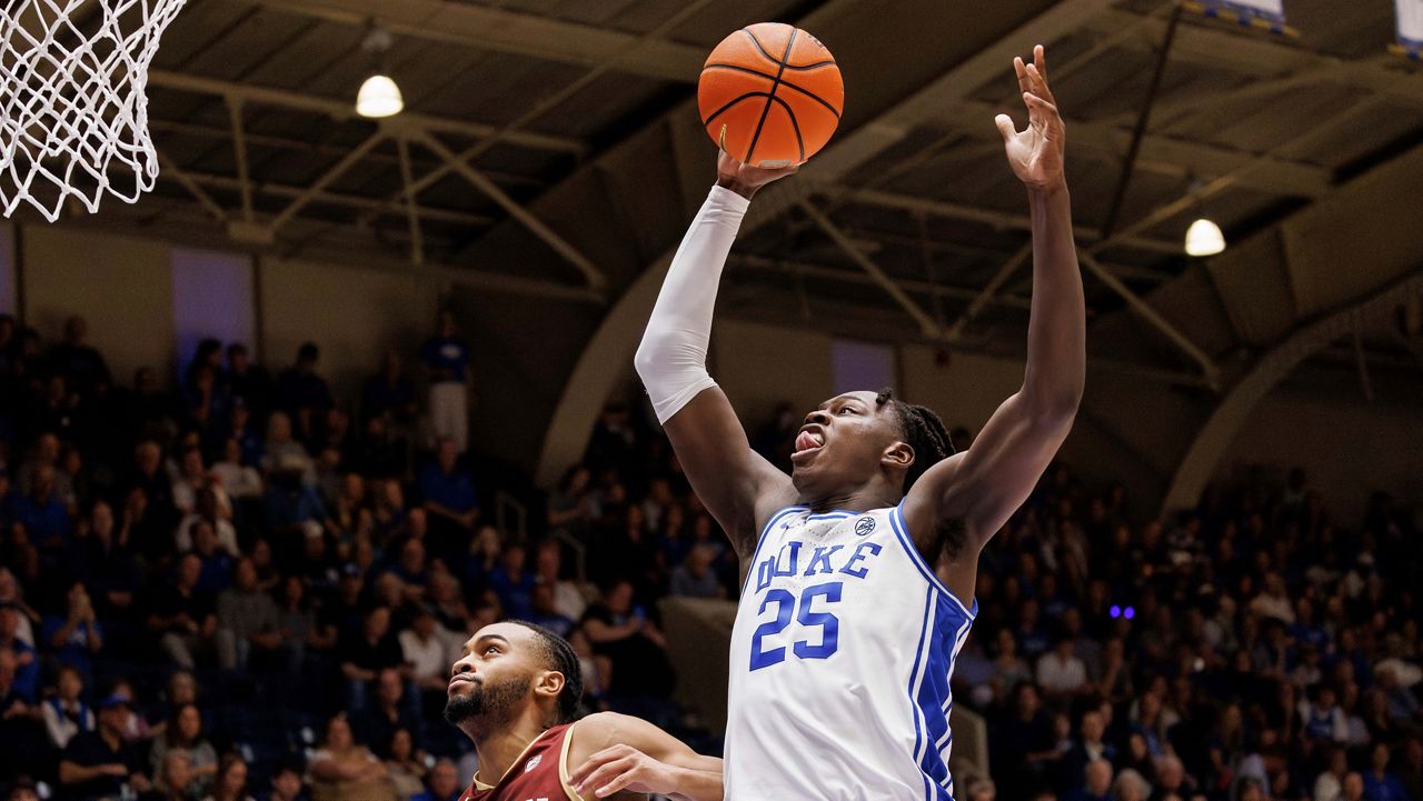 Duke's Mark Mitchell (25) jumps for a shot ahead of Boston College's Claudell Harris Jr. (1) during the second half of an NCAA college basketball game in Durham, N.C., on Saturday, Feb. 10, 2024. (AP Photo/Ben McKeown)