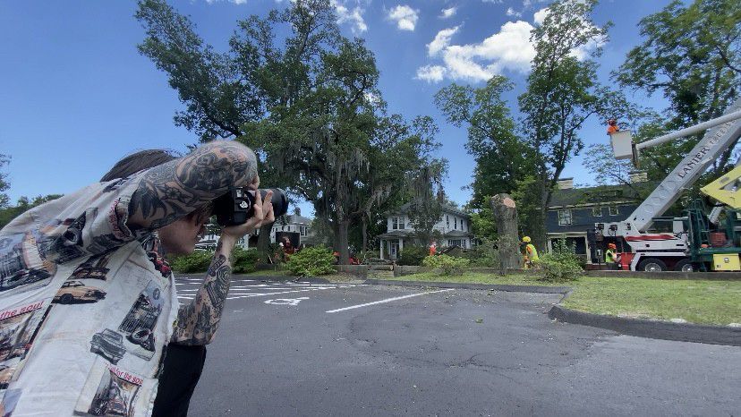 Garion Brodeur photographs the work being done on Market Street. (Spectrum News 1/Natalie Mooney)