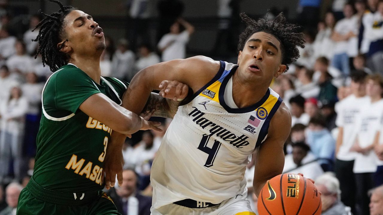 George Mason's Jeremiah Quigley fouls Marquette's Stevie Mitchell 