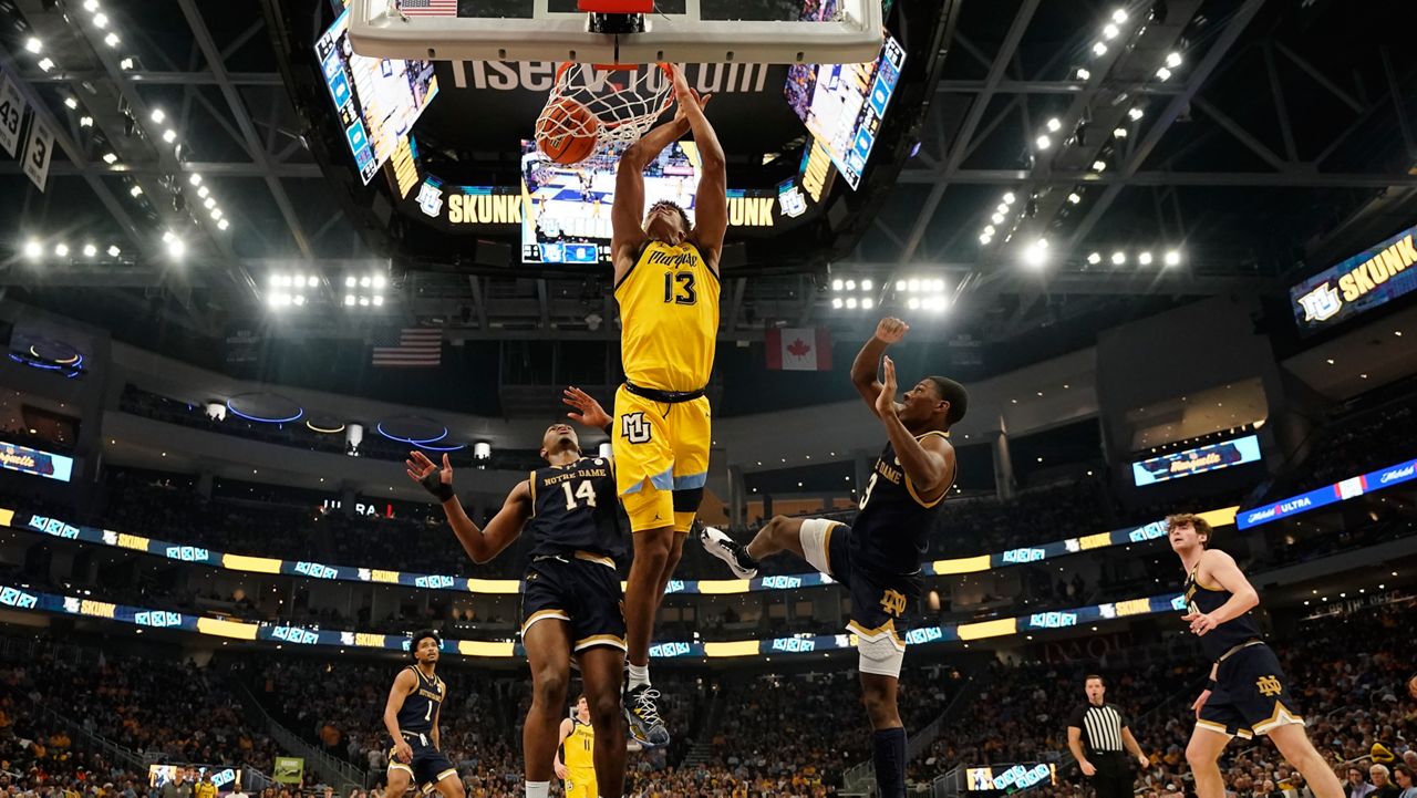 Marquette's Oso Ighodaro dunks past Notre Dame's Markus Burton and Kebba Nji 